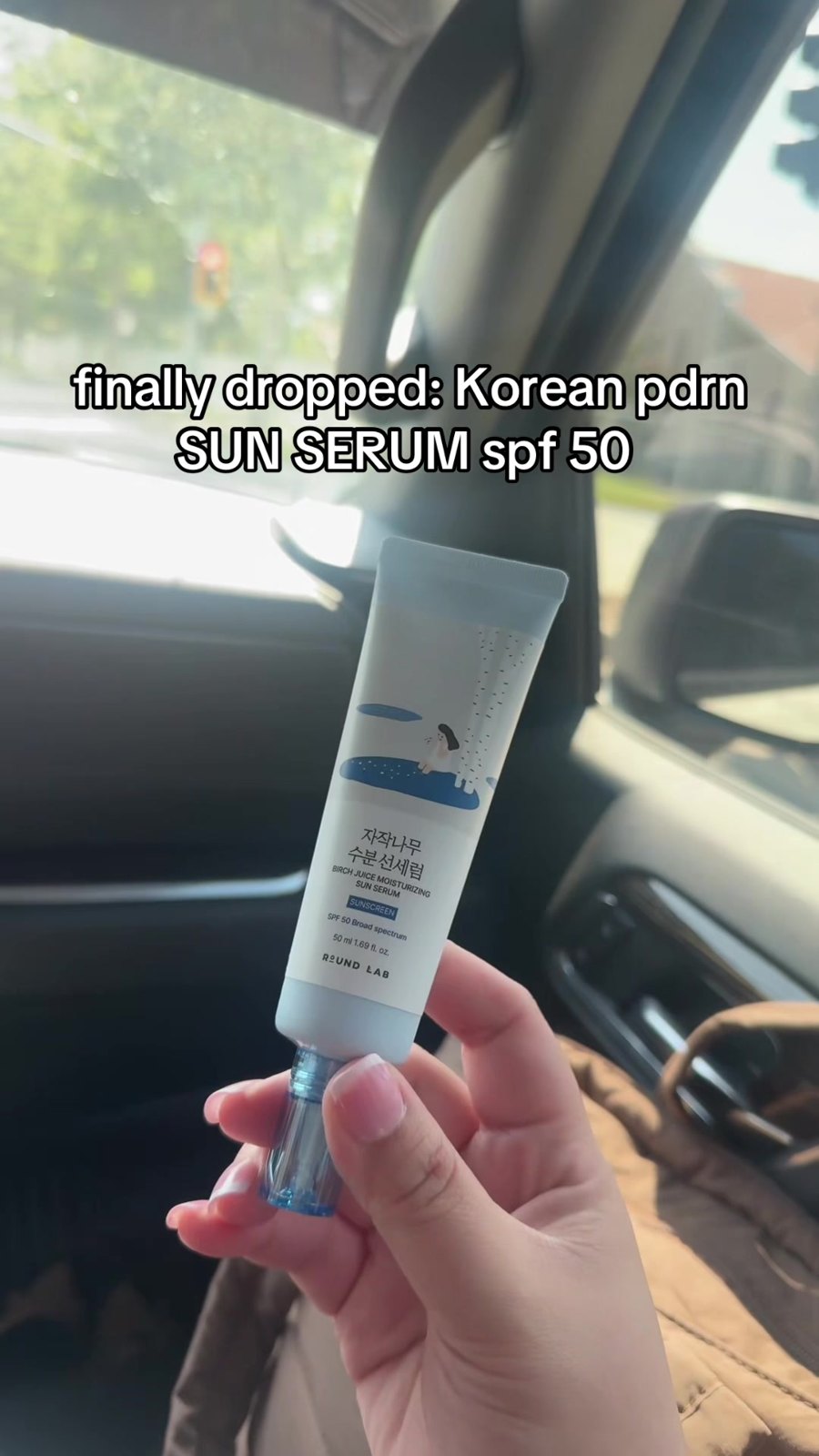 Holding the sun serum tube in the car