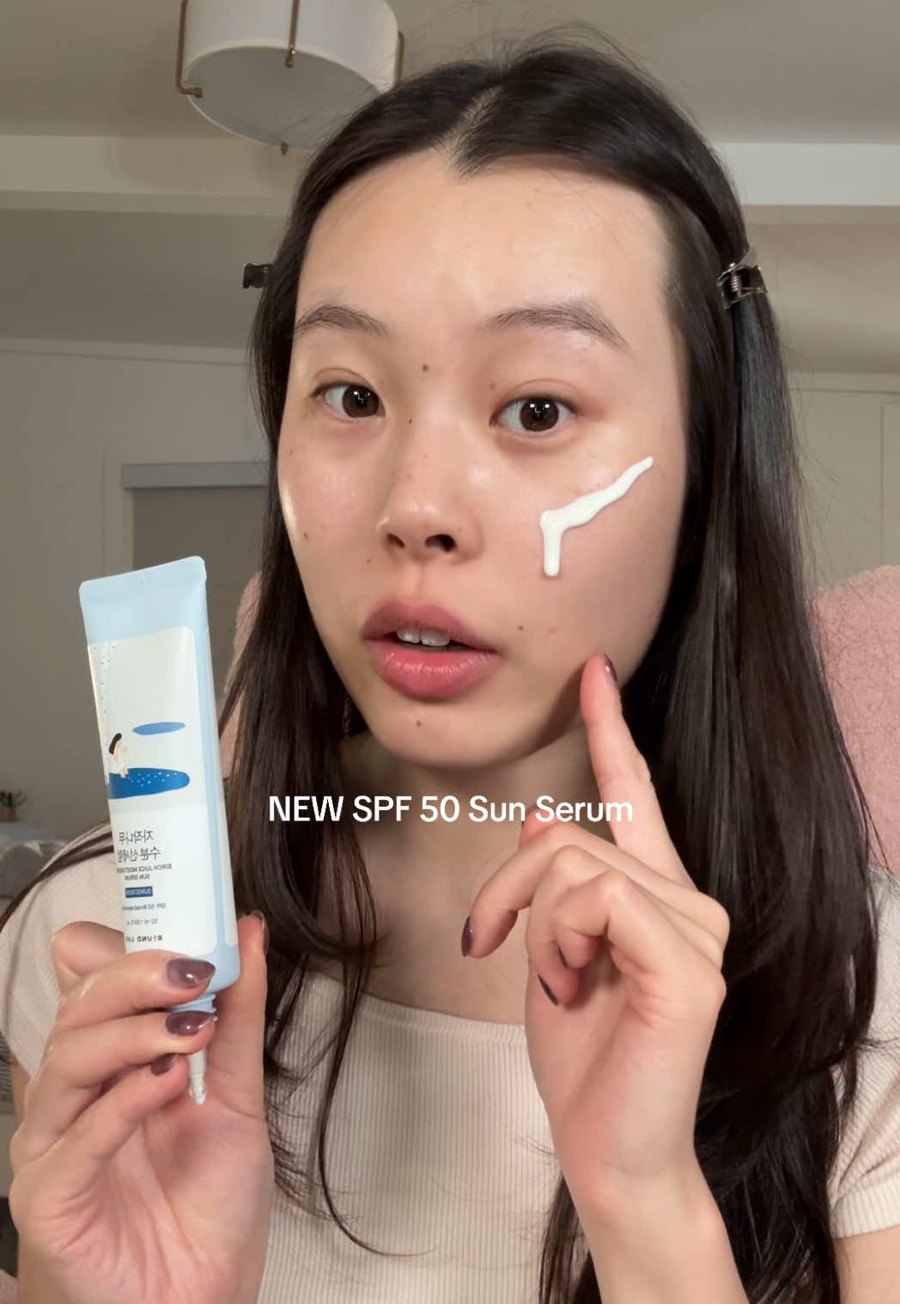 Applying the sun serum on the cheek